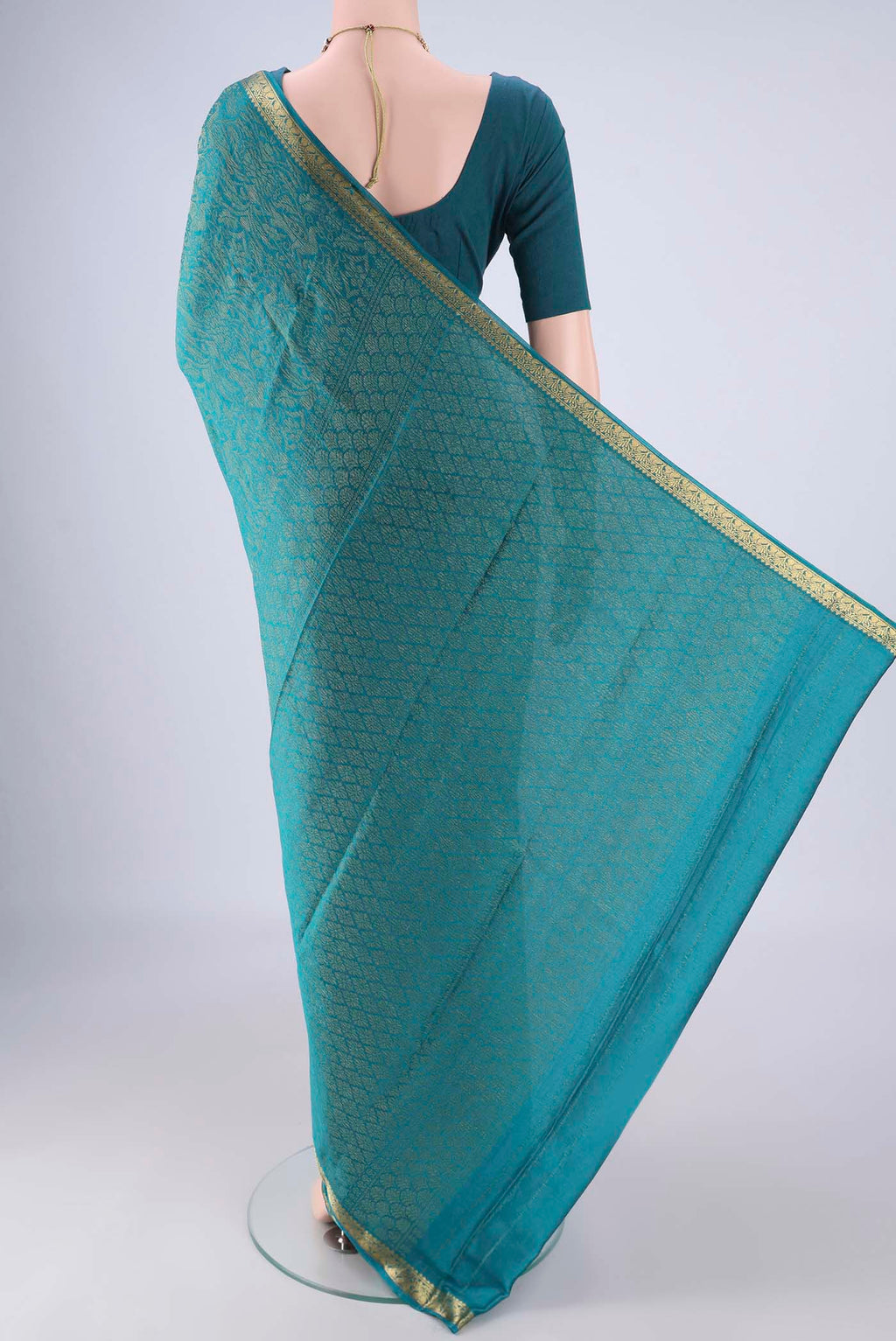 Flat view of Teal Mysore Crepe Saree with Zari Brocade on the body and Zari Border. 