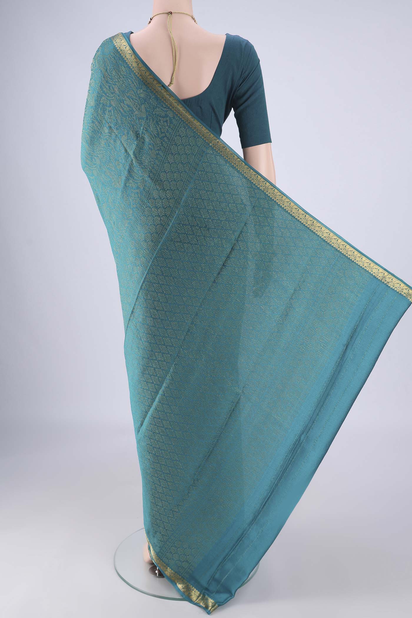 Flat view of Teal Mysore Crepe Saree with Zari Brocade on the body and Zari Border. 