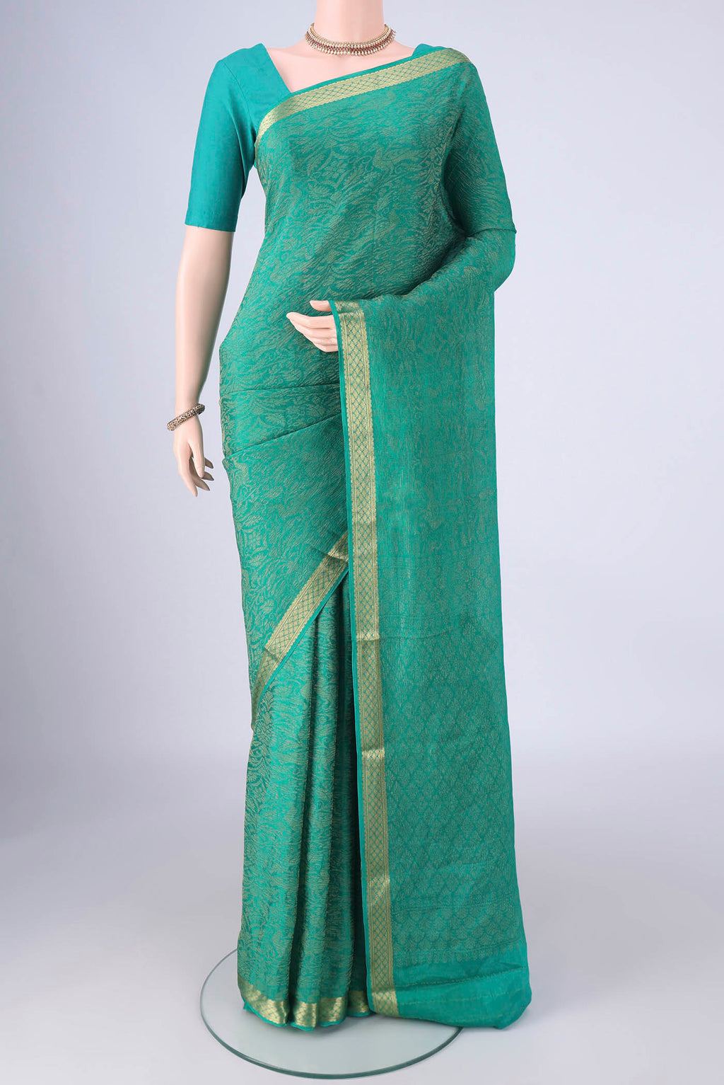 Turquoise Mysore Crepe Saree with Zari Brocade on the body and Zari Border.  displayed on a mannequin
