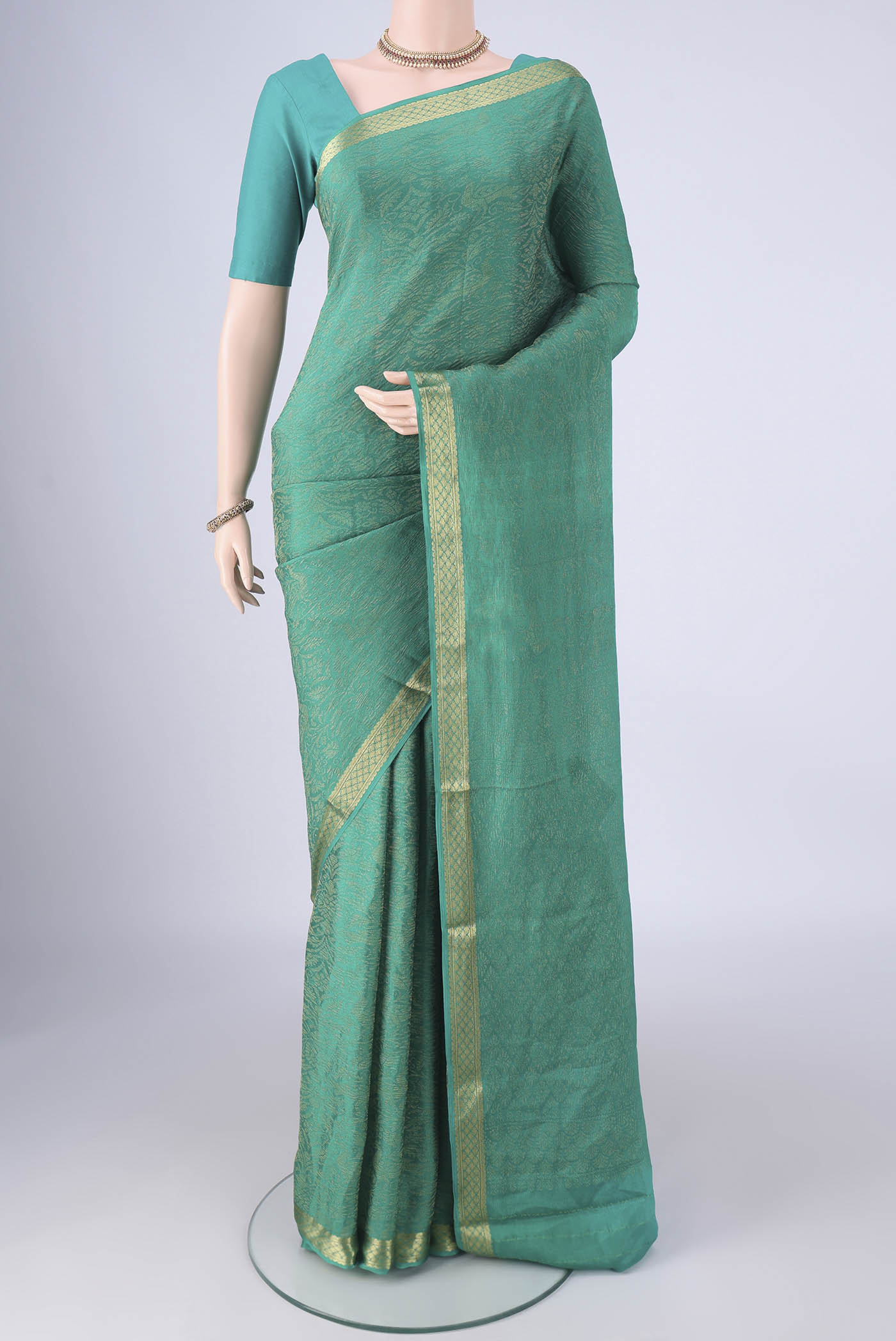 Turquoise Mysore Crepe Saree with Zari Brocade on the body and Zari Border.  displayed on a mannequin
