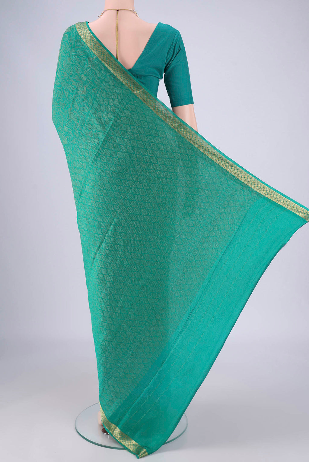 Flat view of Turquoise Mysore Crepe Saree with Zari Brocade on the body and Zari Border. 