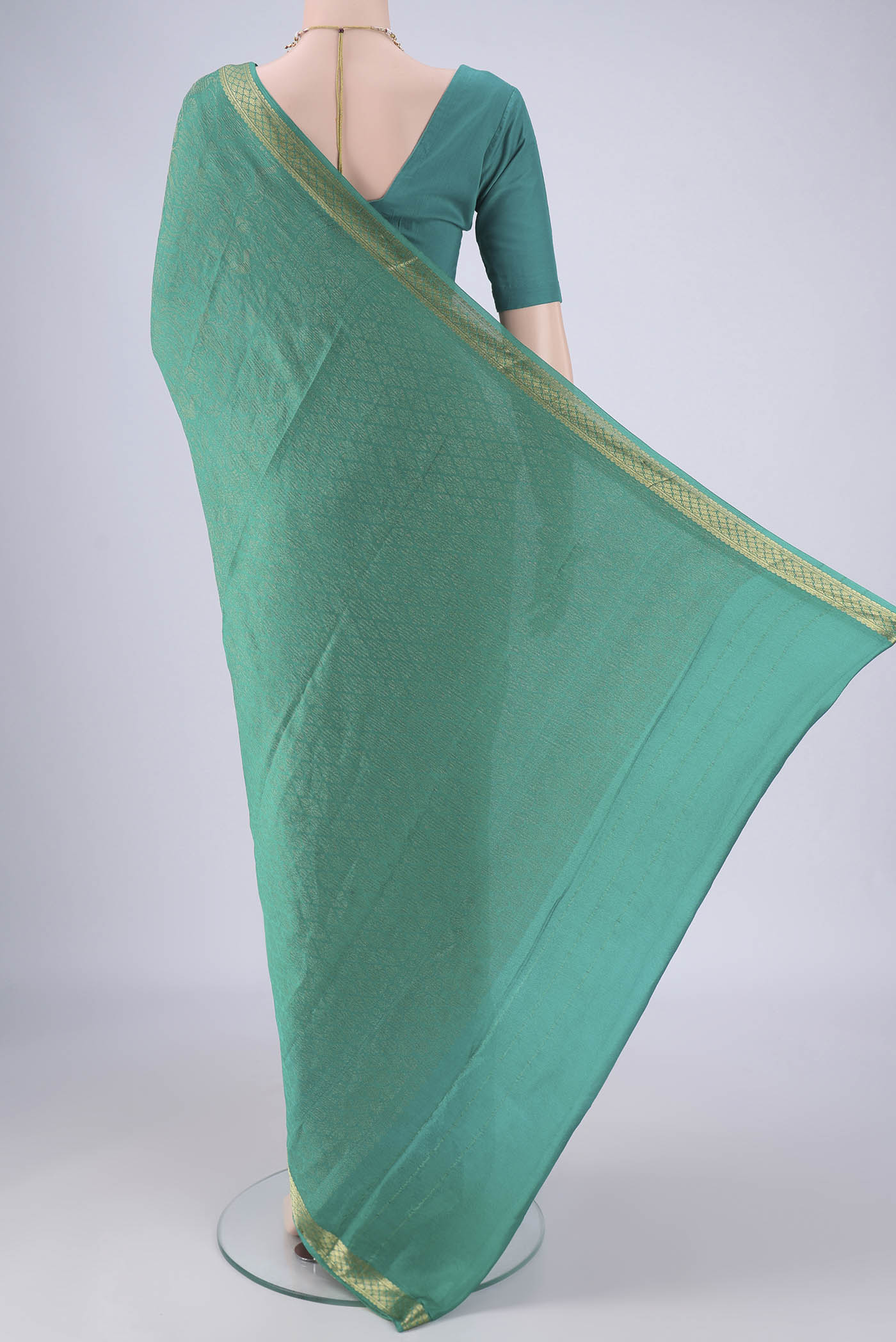 Flat view of Turquoise Mysore Crepe Saree with Zari Brocade on the body and Zari Border. 