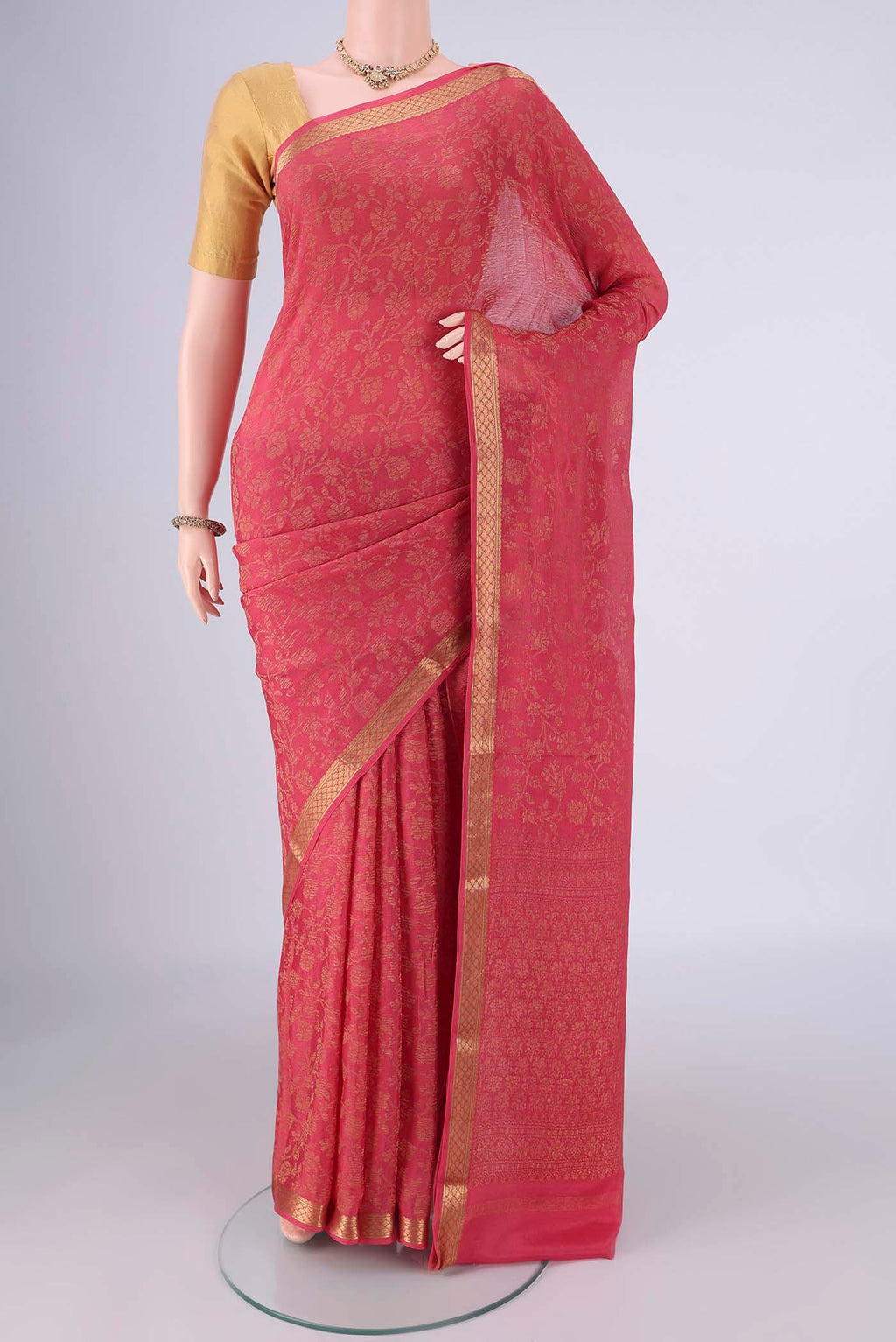 Peach Mysore Crepe Saree with Zari Brocade on the body and Zari Border.  displayed on a mannequin
