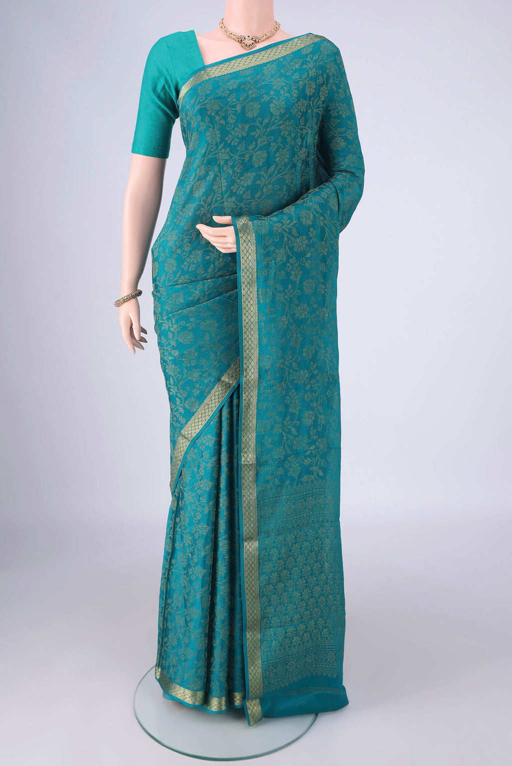 Turquoise Mysore Crepe Saree with Zari Brocade on the body and Zari Border.  displayed on a mannequin