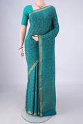 Turquoise Mysore Crepe Saree with Zari Brocade on the body and Zari Border.  displayed on a mannequin