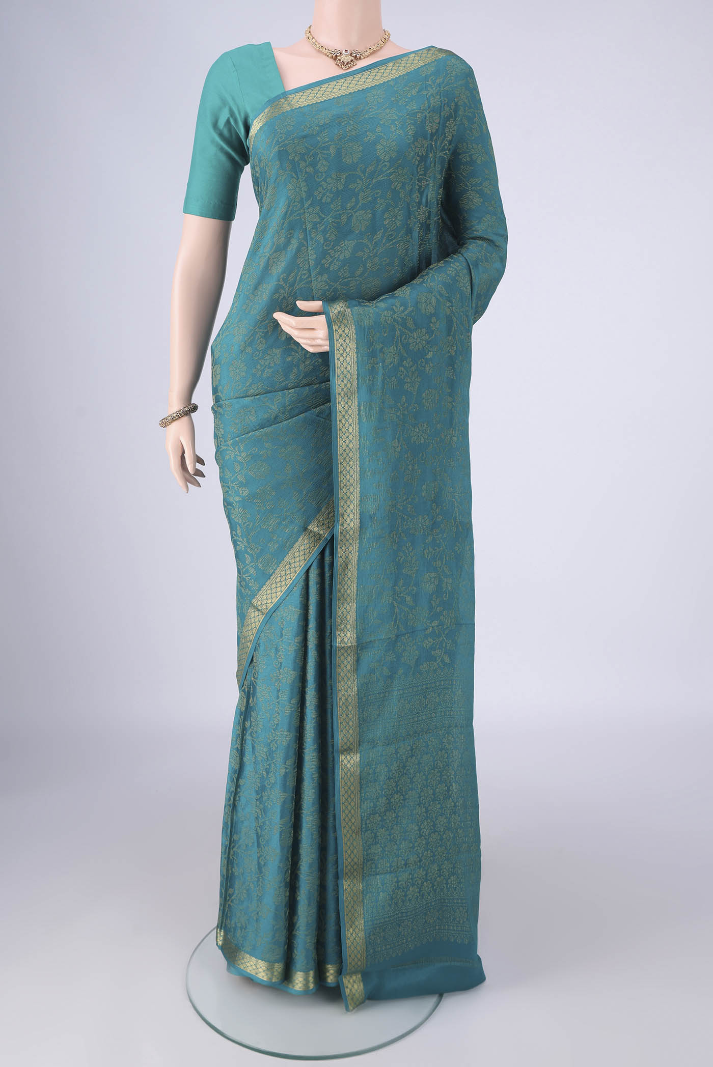 Turquoise Mysore Crepe Saree with Zari Brocade on the body and Zari Border.  displayed on a mannequin
