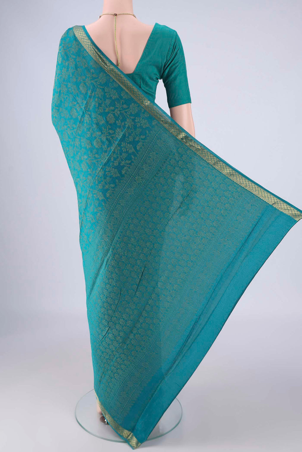 Flat view of Turquoise Mysore Crepe Saree with Zari Brocade on the body and Zari Border. 