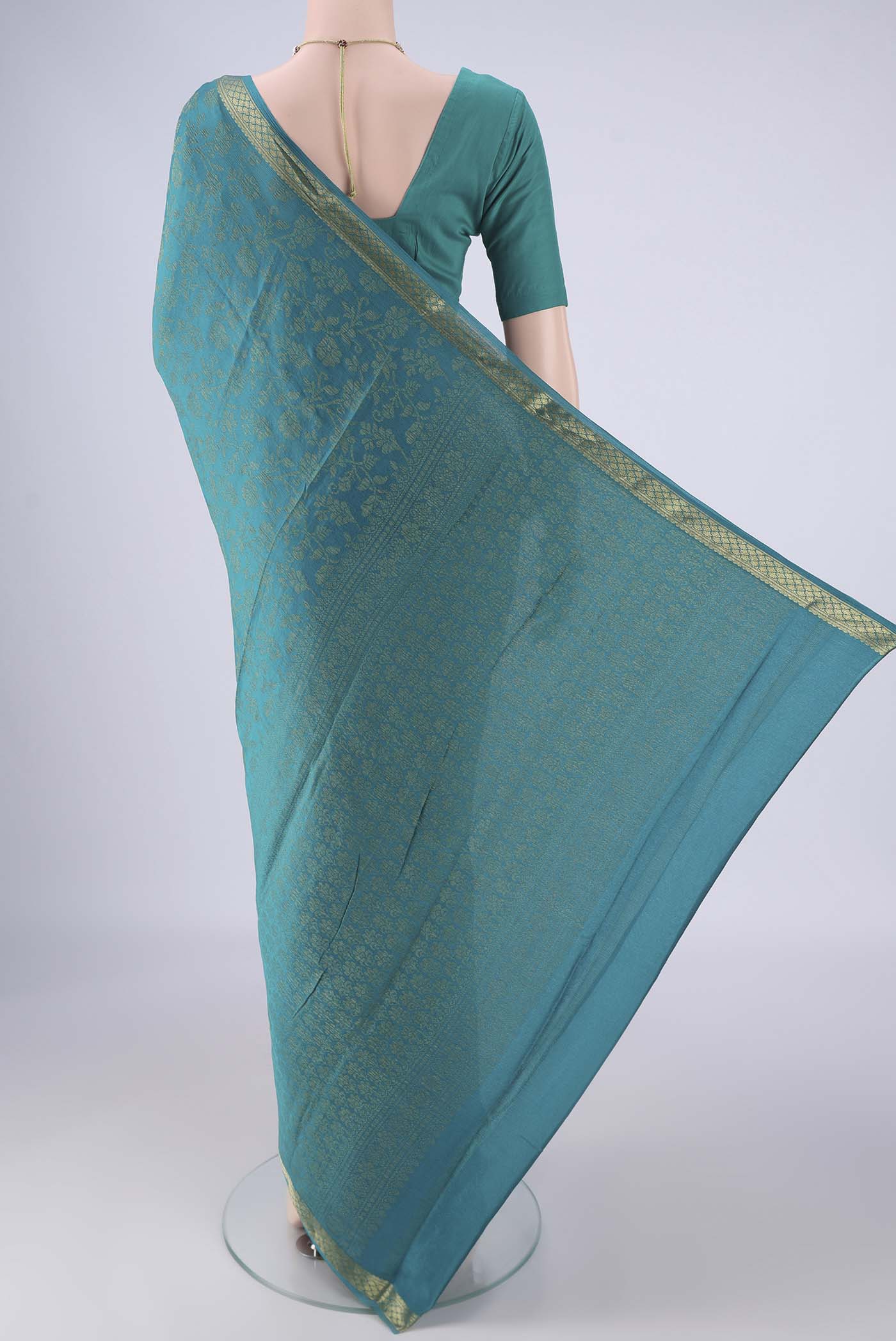Flat view of Turquoise Mysore Crepe Saree with Zari Brocade on the body and Zari Border. 