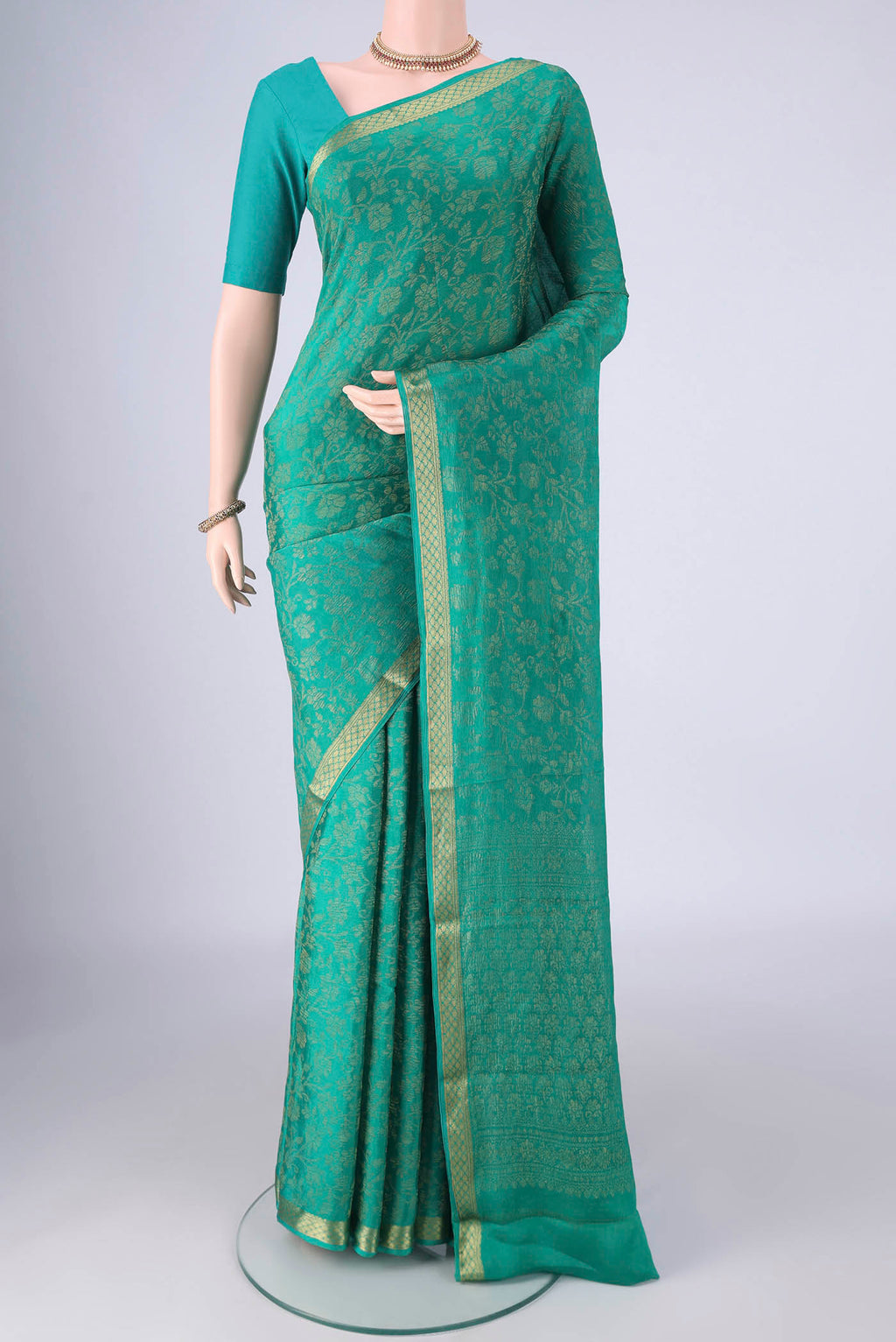 Turquoise Mysore Crepe Saree with Zari Brocade on the body and Zari Border.  displayed on a mannequin