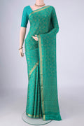 Turquoise Mysore Crepe Saree with Zari Brocade on the body and Zari Border.  displayed on a mannequin