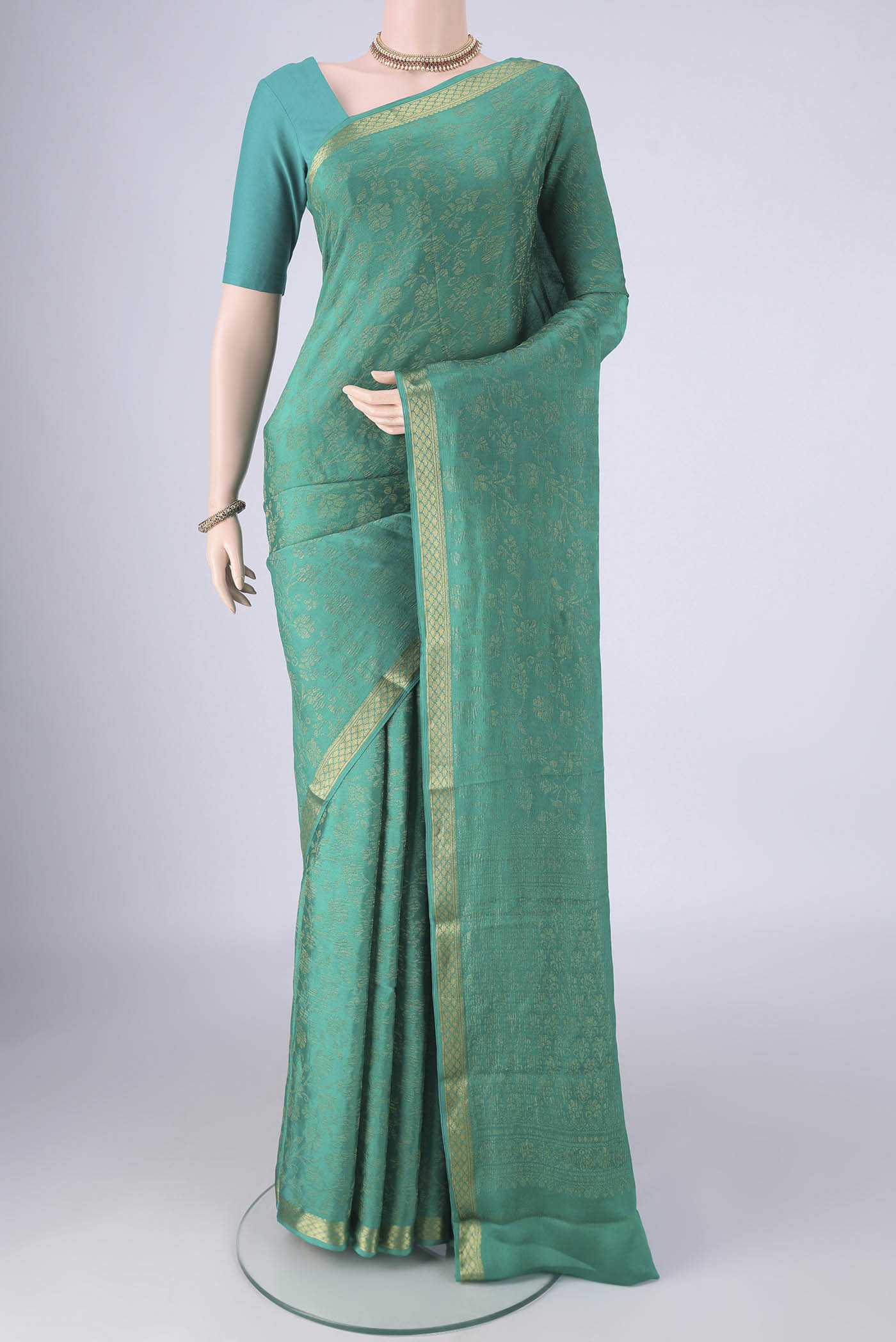 Turquoise Mysore Crepe Saree with Zari Brocade on the body and Zari Border.  displayed on a mannequin