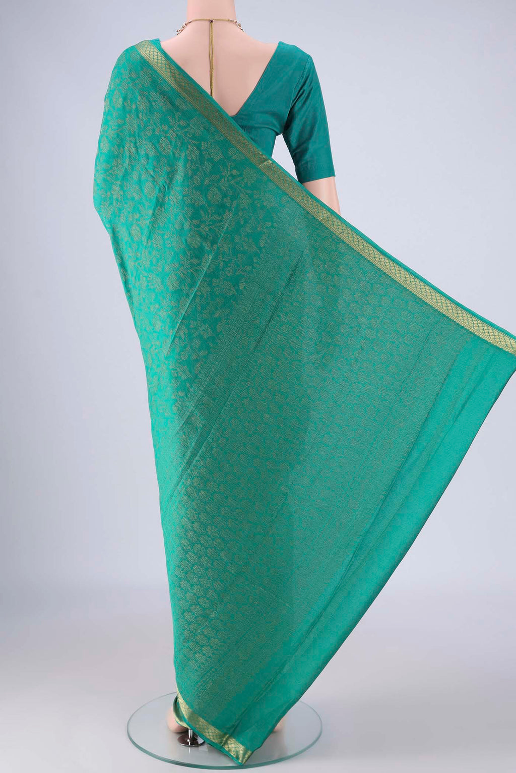 Flat view of Turquoise Mysore Crepe Saree with Zari Brocade on the body and Zari Border. 
