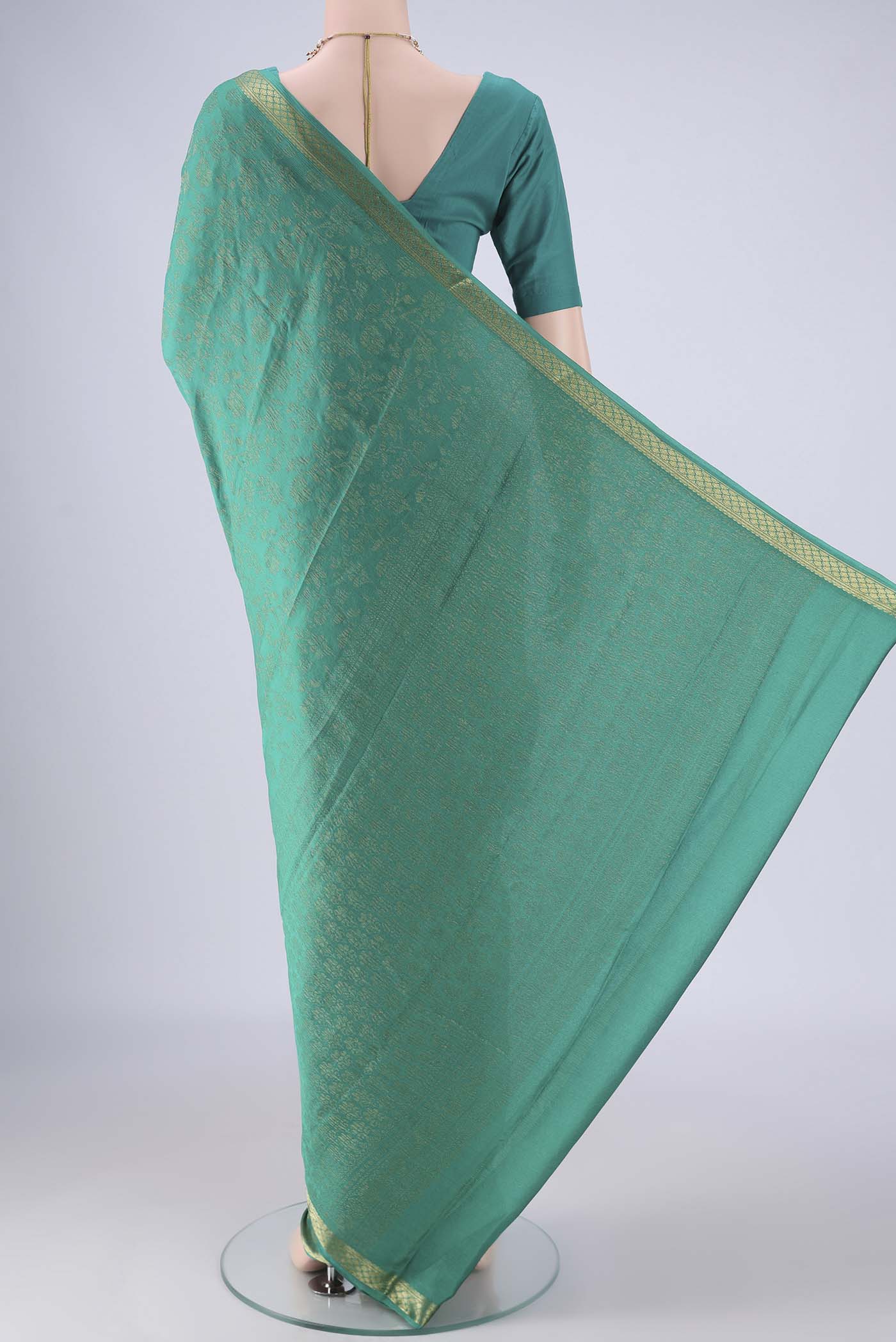 Flat view of Turquoise Mysore Crepe Saree with Zari Brocade on the body and Zari Border. 