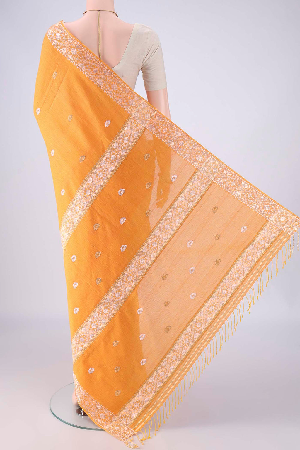 Flat view of Orange Assam Cotton Saree with Thread Butta on the body and Thread Border. 