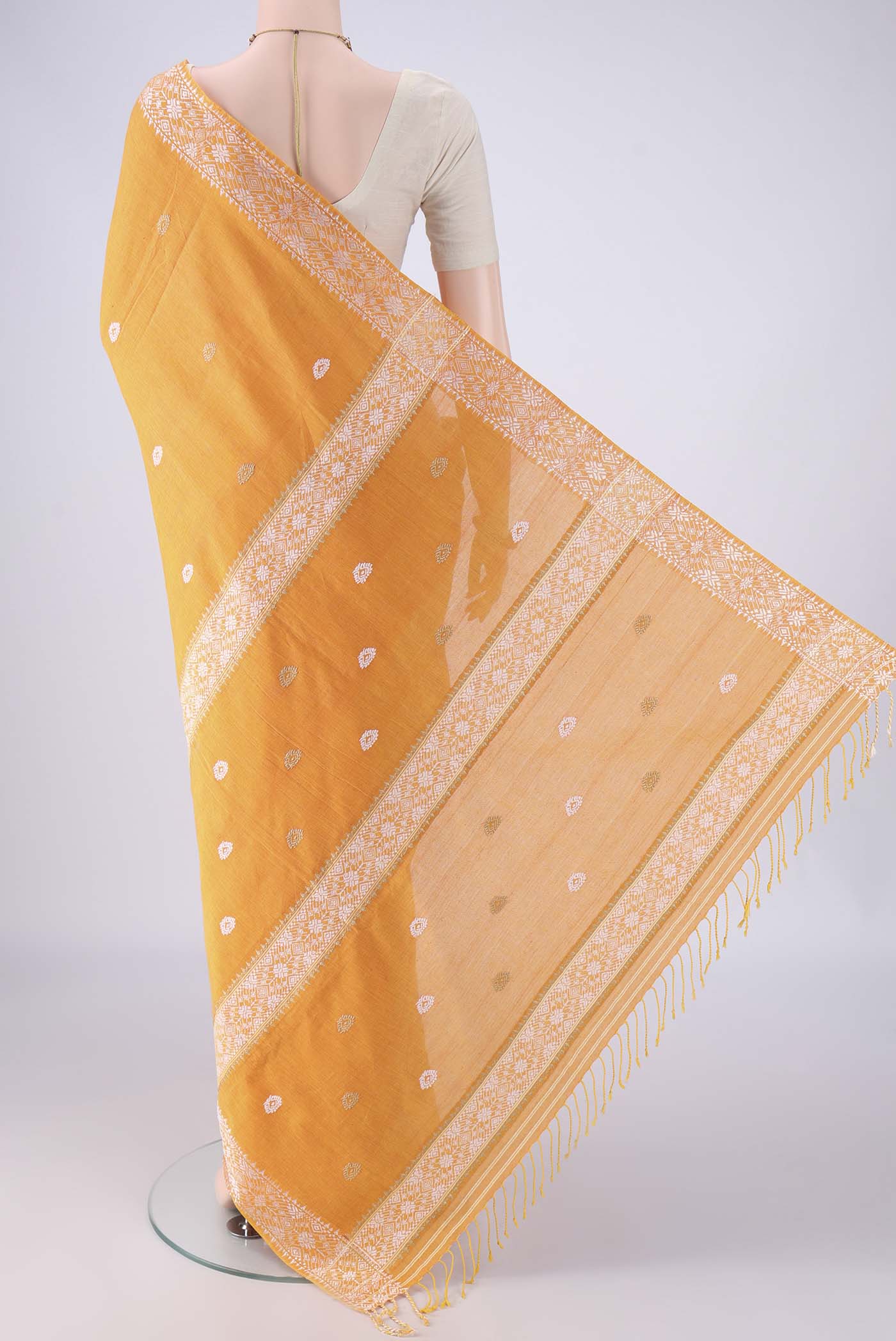 Flat view of Orange Assam Cotton Saree with Thread Butta on the body and Thread Border. 