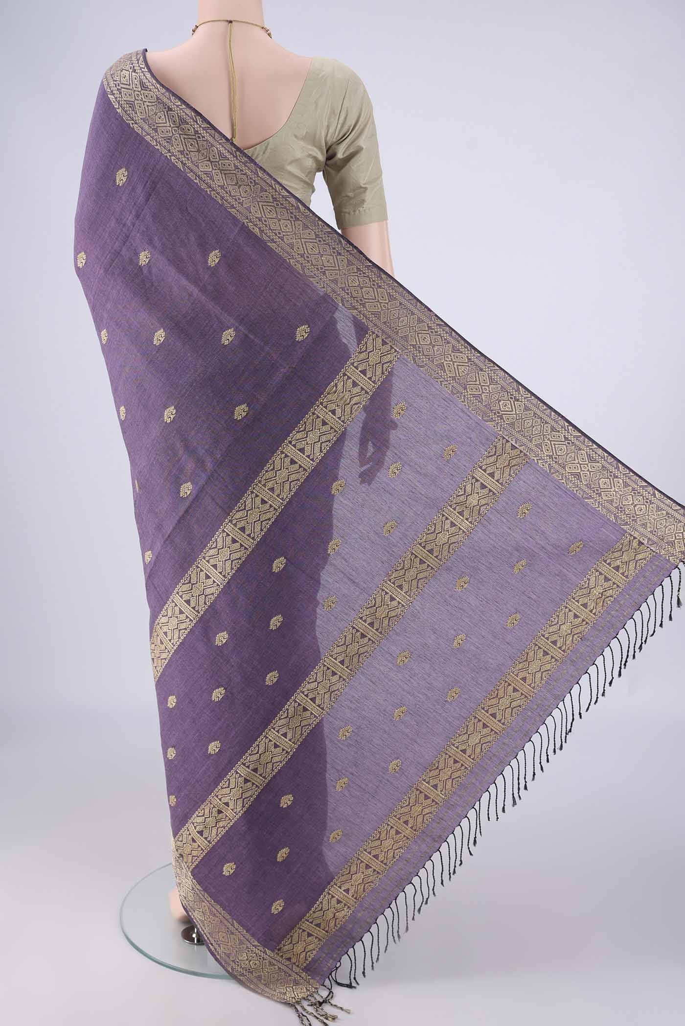 Flat view of Lilac Assam Cotton Saree with Thread Butta on the body and Thread Border. 