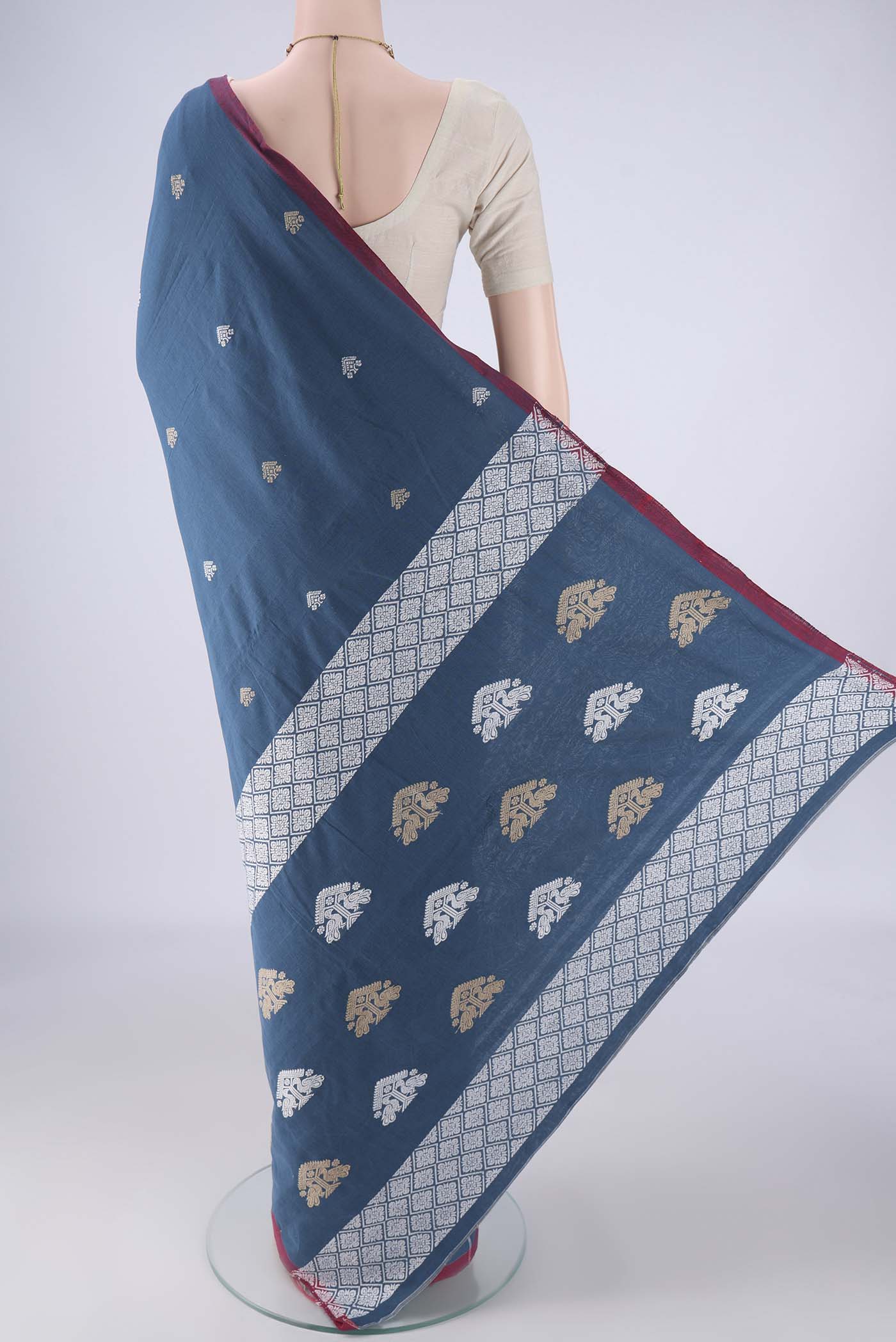 Flat view of Blue Assam Cotton Saree with Thread Butta on the body and Thread Border. 