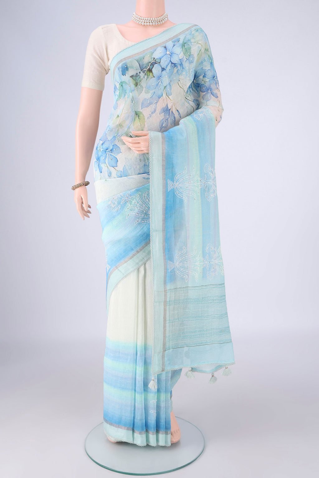 Off White Linen Saree with Floral Print on the body and Thin Zari Line.  displayed on a mannequin