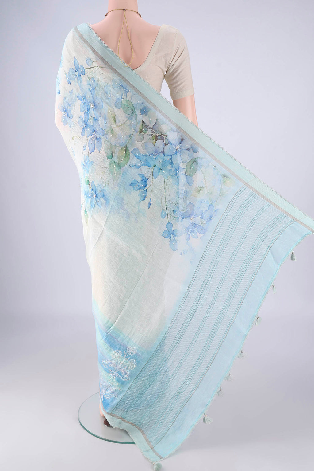 Flat view of Off White Linen Saree with Floral Print on the body and Thin Zari Line. 
