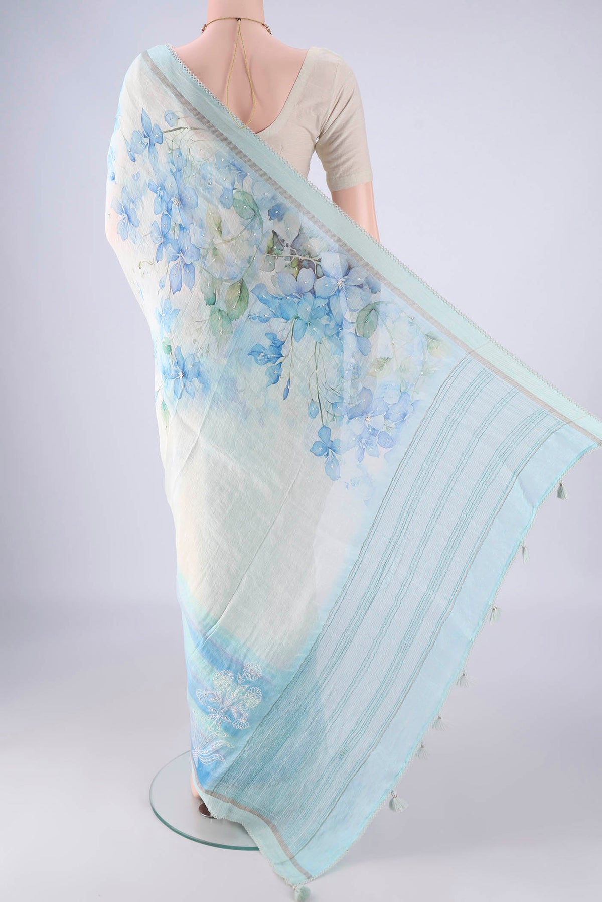 Flat view of Off White Linen Saree with Floral Print on the body and Thin Zari Line. 