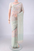 Rose Gold Linen Saree with Embroidery on the body and Zari Border.  displayed on a mannequin