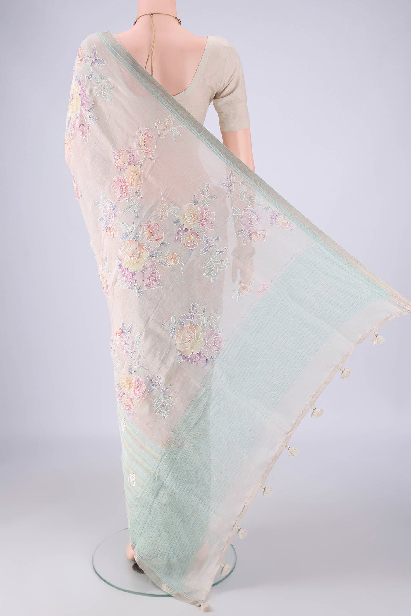 Flat view of Rose Gold Linen Saree with Embroidery on the body and Zari Border. 
