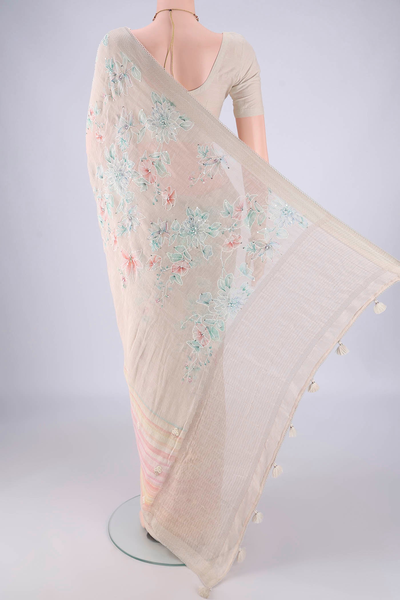 Flat view of Beige Linen Saree with Embroidery on the body and Zari Border. 