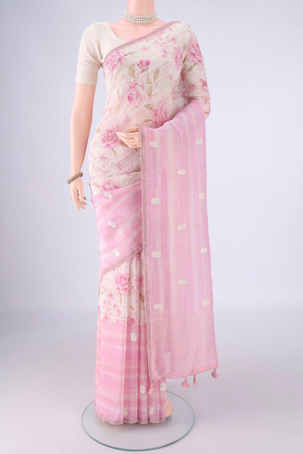 Rose pink Linen Saree with Embroidery on the body and Thin Zari Line.  displayed on a mannequin
