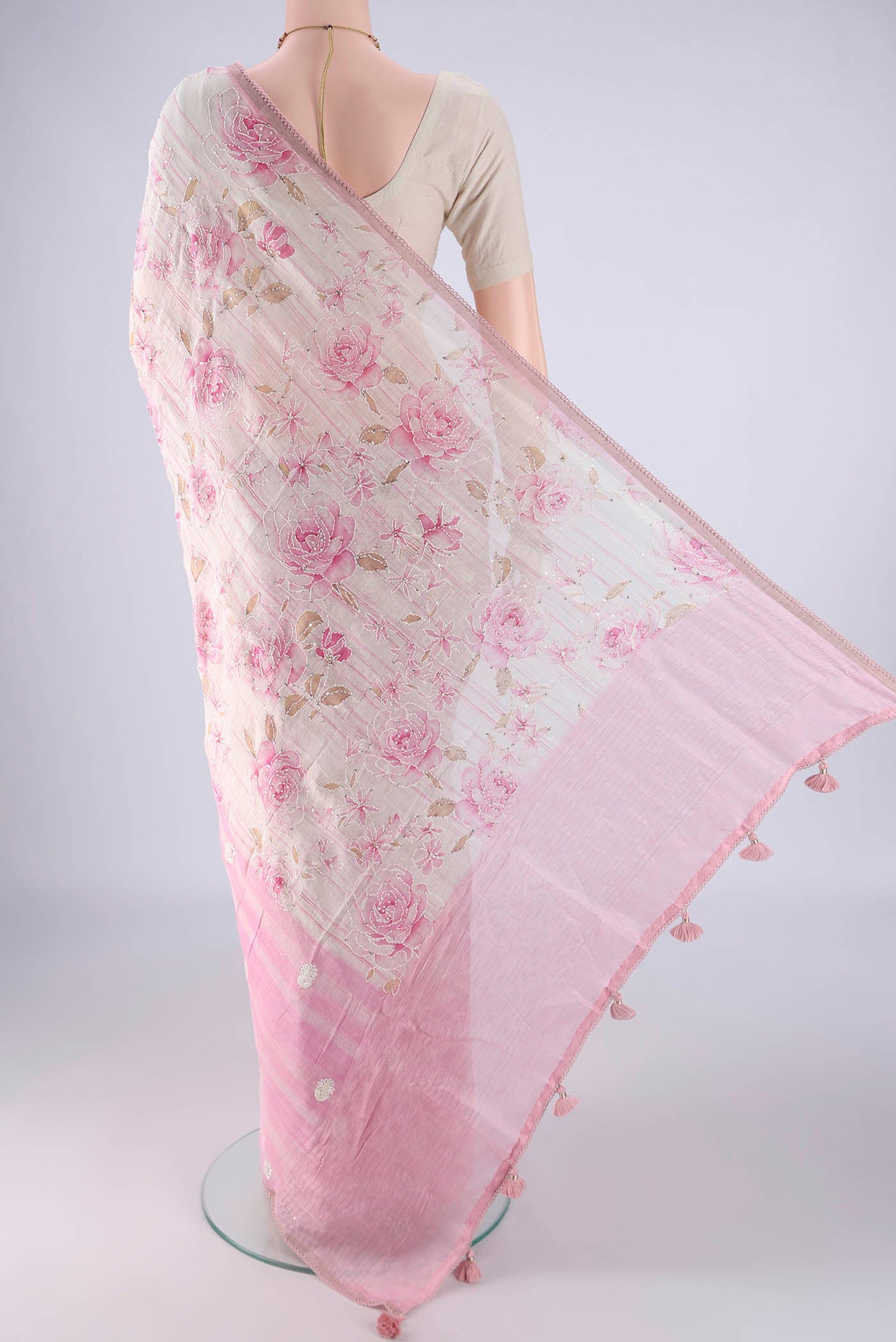 Flat view of Rose pink Linen Saree with Embroidery on the body and Thin Zari Line. 