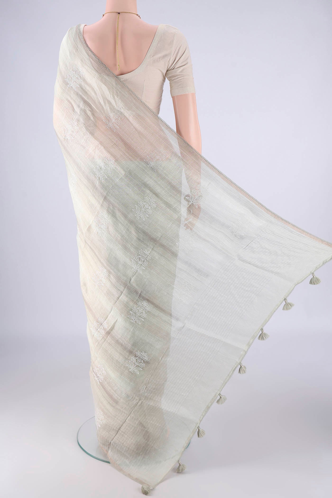 Flat view of Off White Linen Saree with Embroidery on the body and Thin Zari Line. 