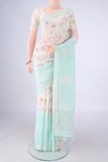 Off White Linen Saree with Printed design on the body and Thin Zari Line.  displayed on a mannequin