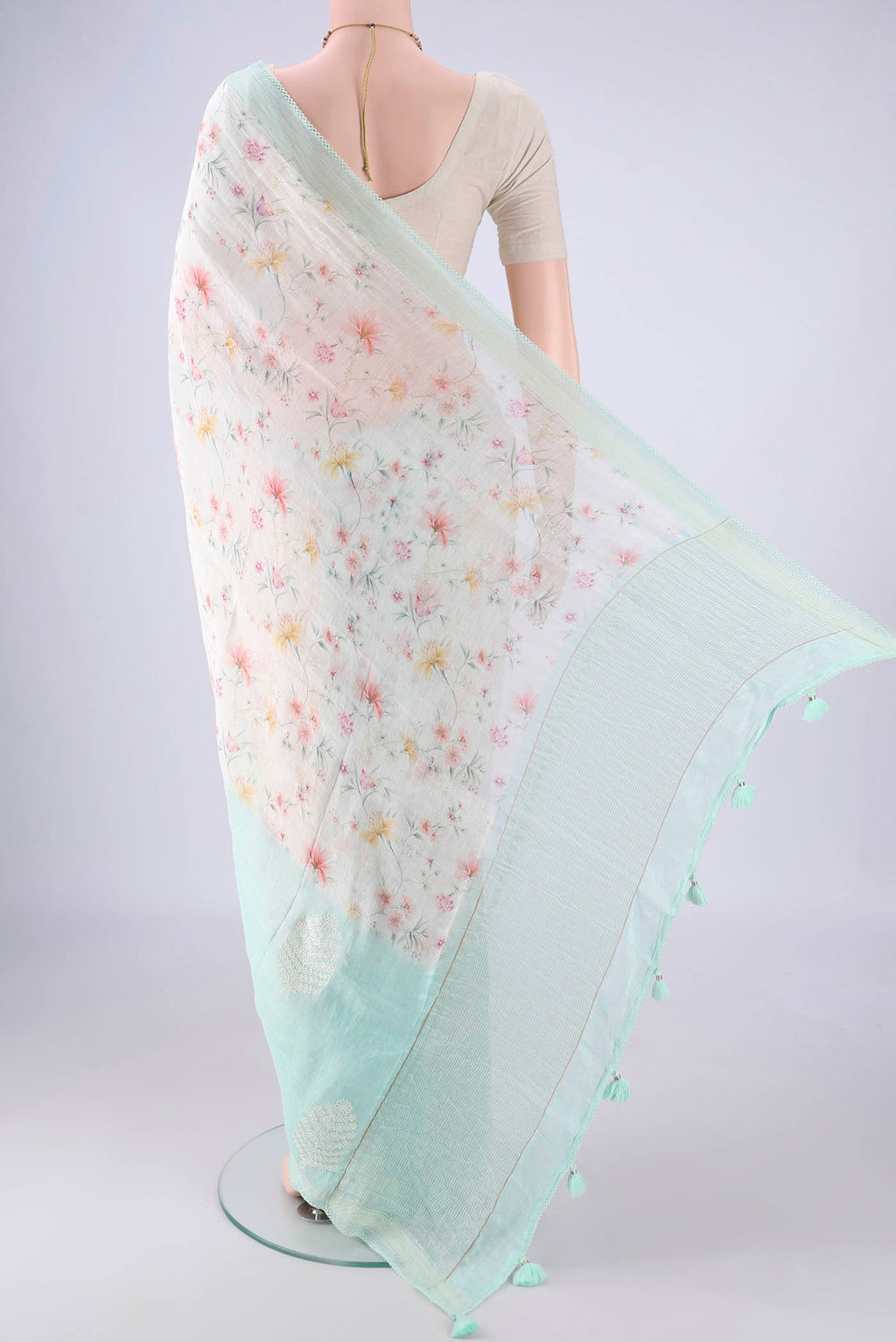Flat view of Off White Linen Saree with Printed design on the body and Thin Zari Line. 