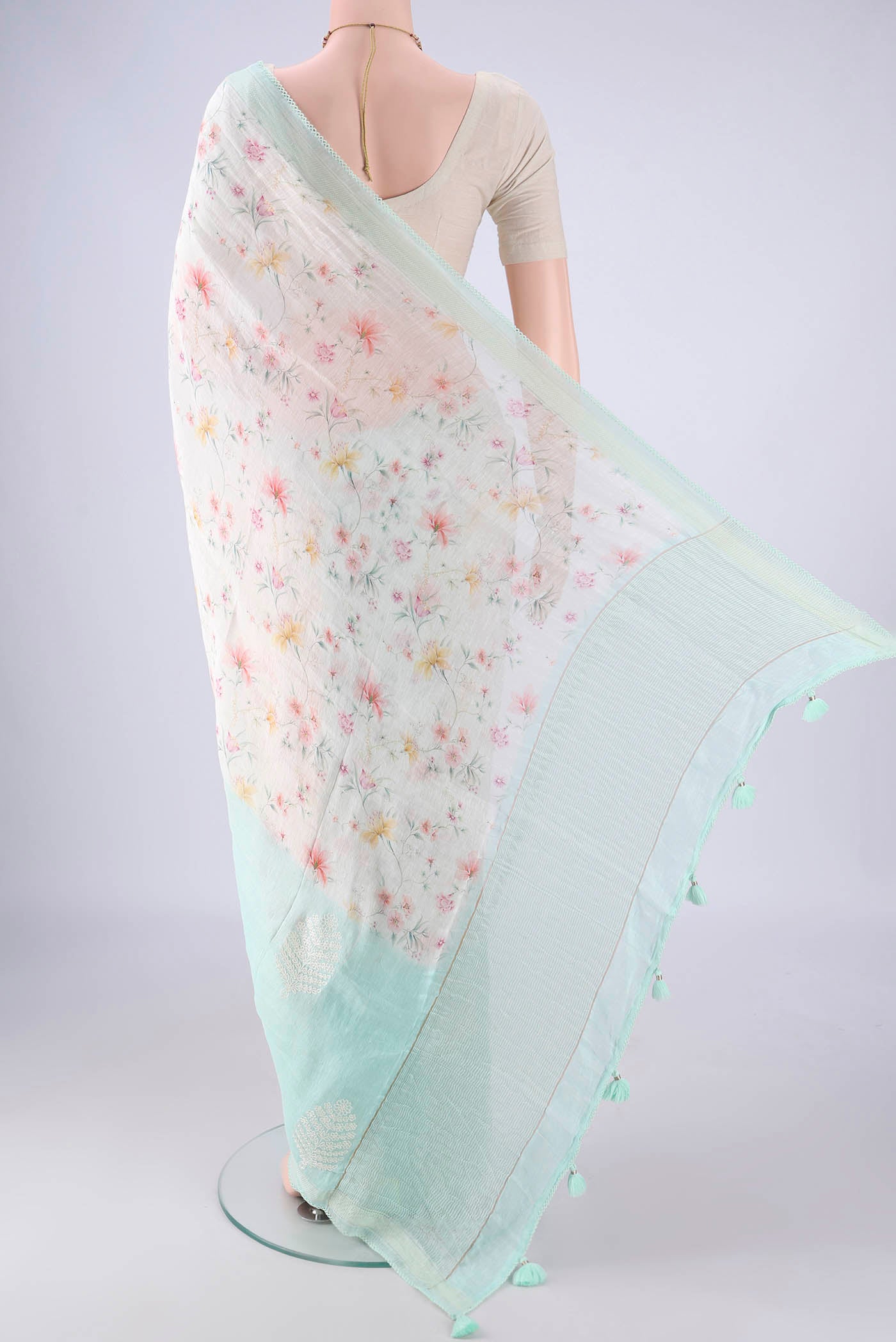 Flat view of Off White Linen Saree with Printed design on the body and Thin Zari Line. 