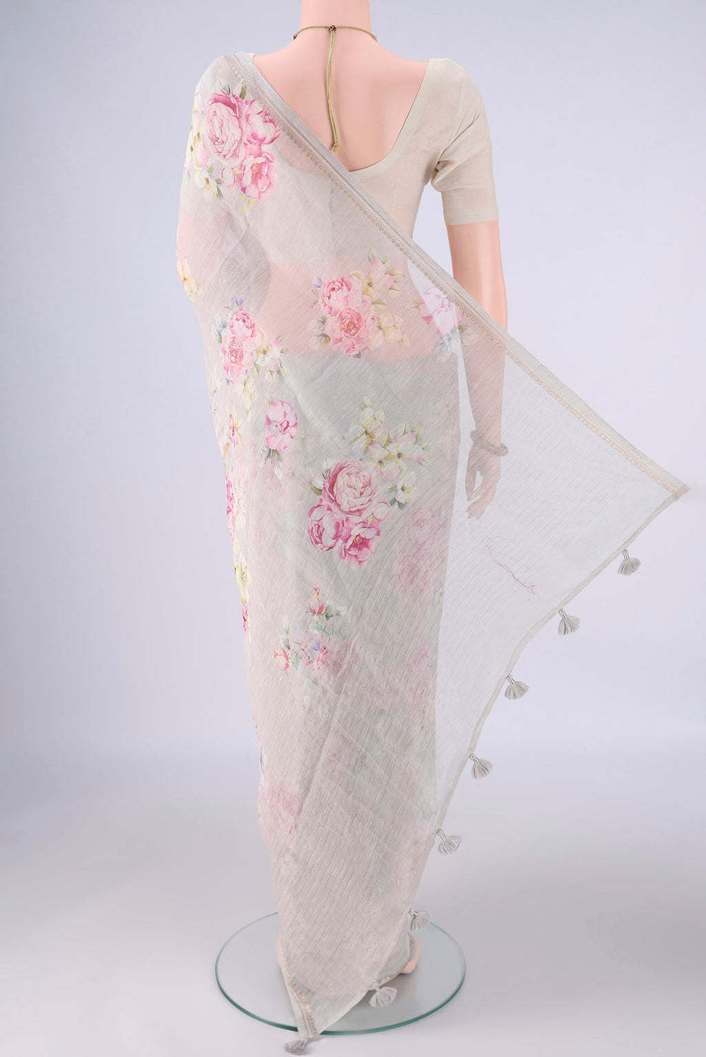 Flat view of Grey Linen Saree with Floral Print on the body and Zari Border. 