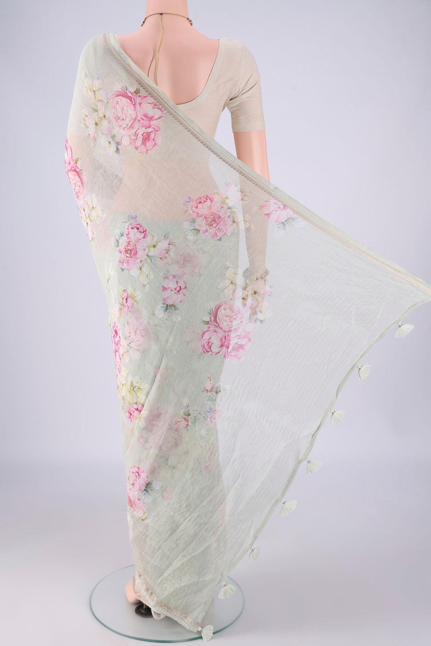 Flat view of Sage Green Linen Saree with Floral Print on the body and Zari Border. 