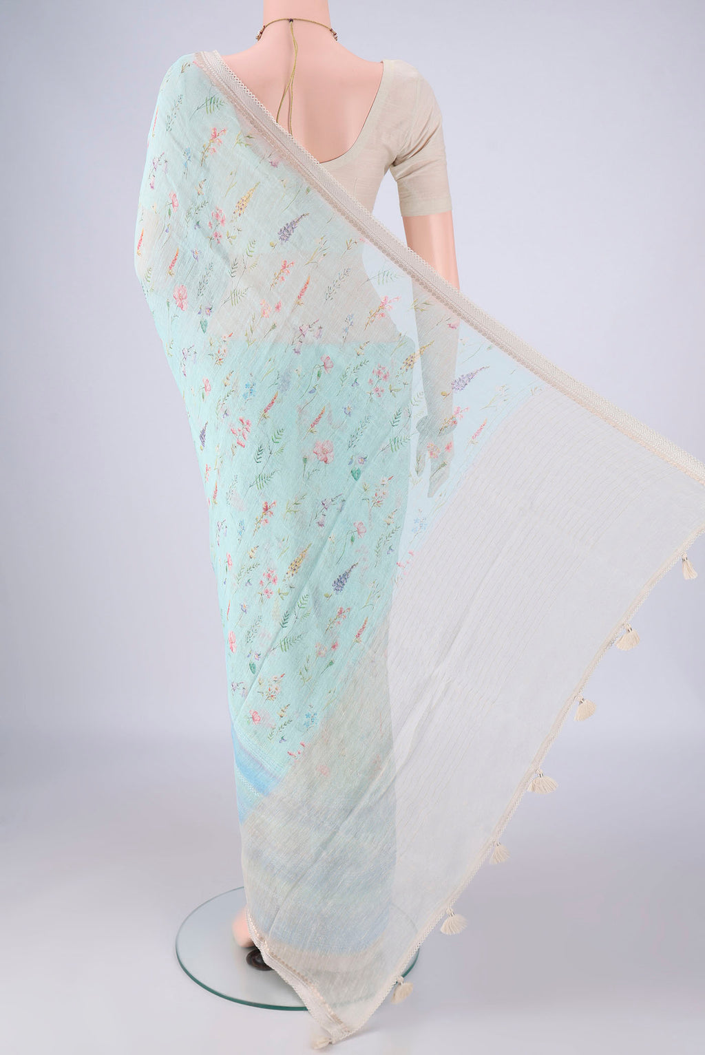 Flat view of Sky Blue Linen Saree with Printed design on the body and Zari Border. 