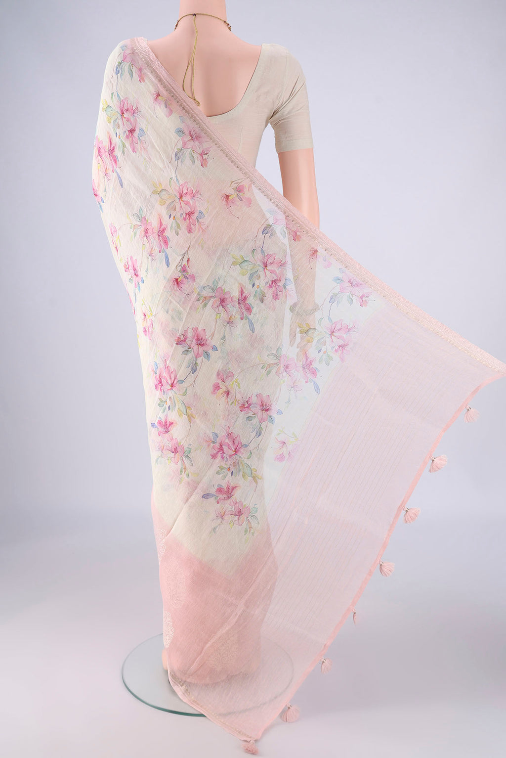Flat view of Off White Linen Saree with Floral Print on the body and Lace Border. 