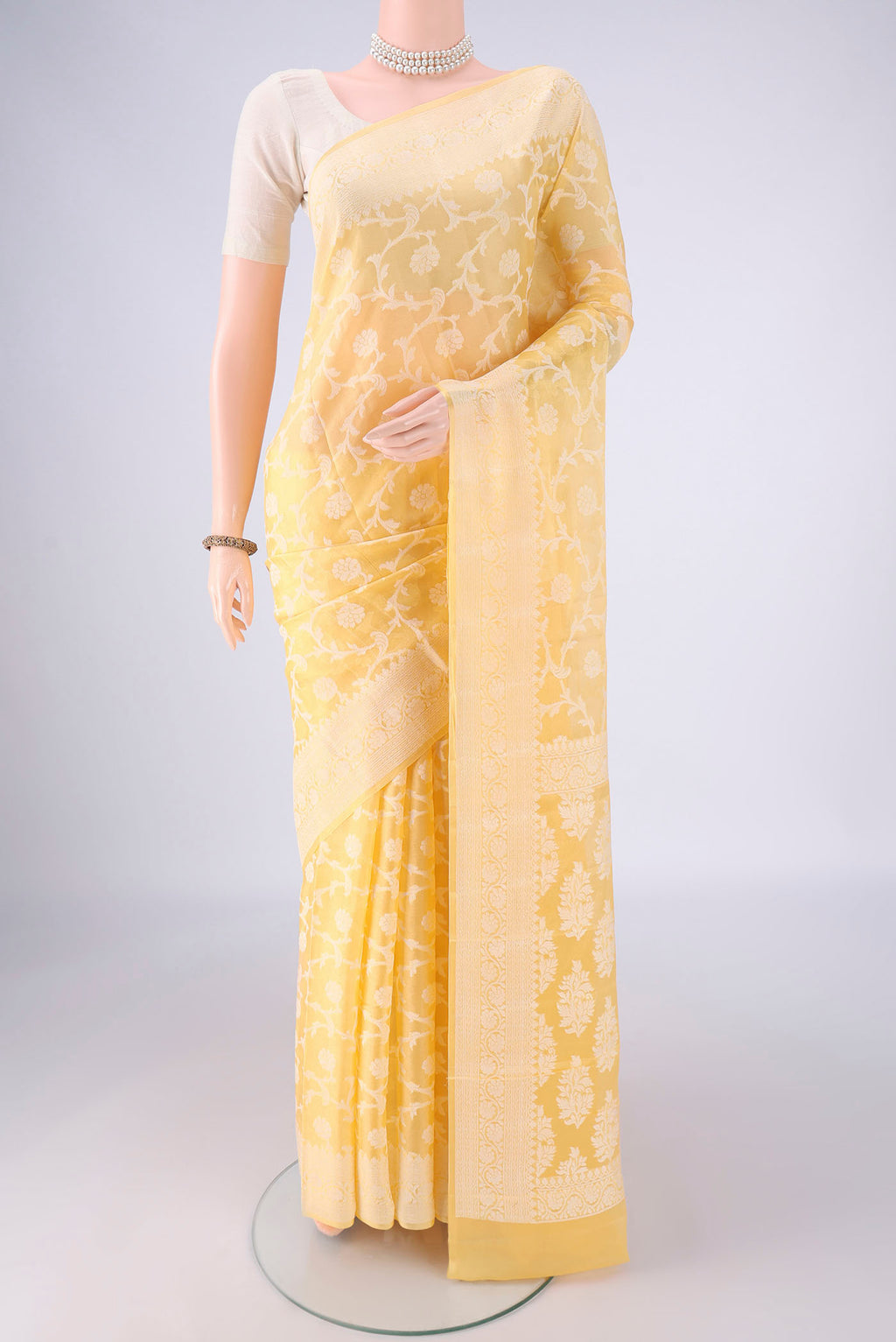 Yellow Blended Banarasi Georgette Saree with Thread Brocade on the body and Thread Border.  displayed on a mannequin