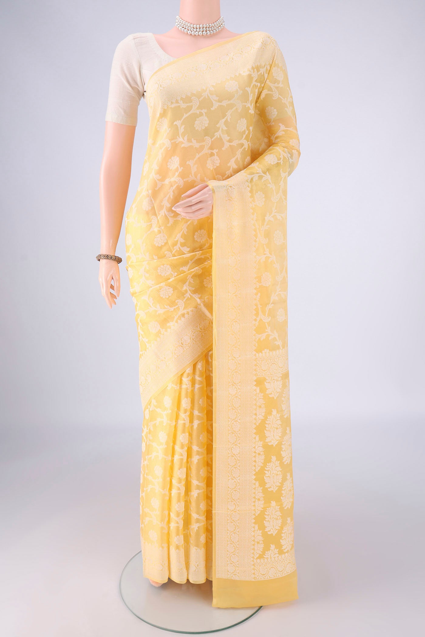 Yellow Blended Banarasi Georgette Saree with Thread Brocade on the body and Thread Border.  displayed on a mannequin