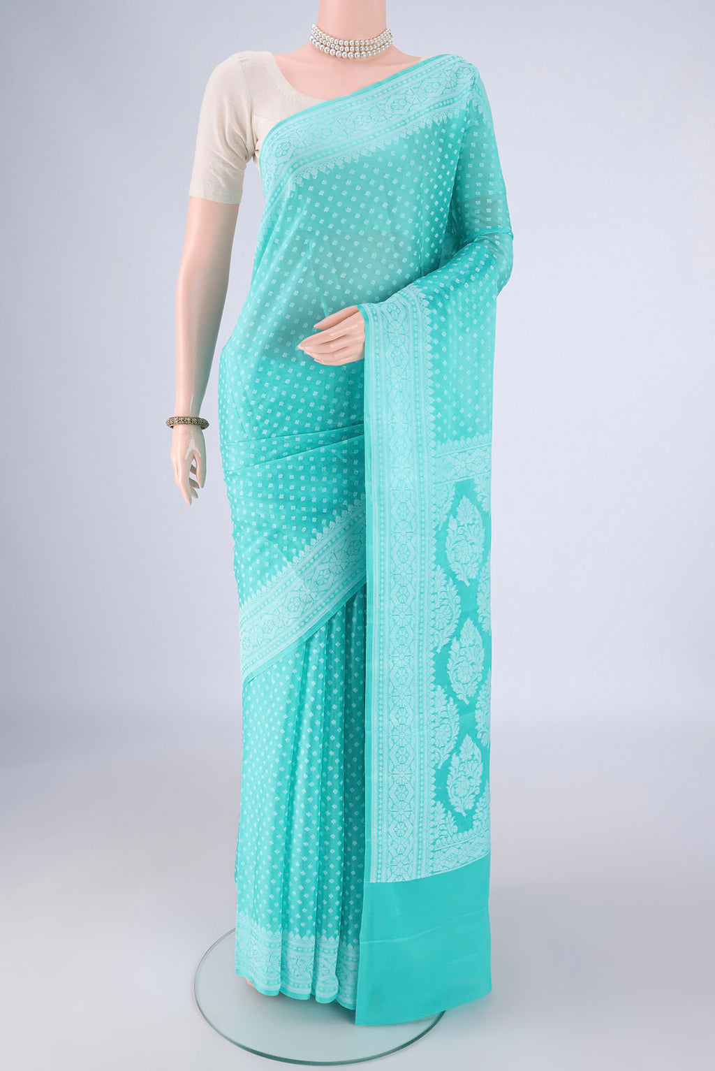 Sky Blue Blended Banarasi Georgette Saree with Thread Butta on the body and Thread Border.  displayed on a mannequin
