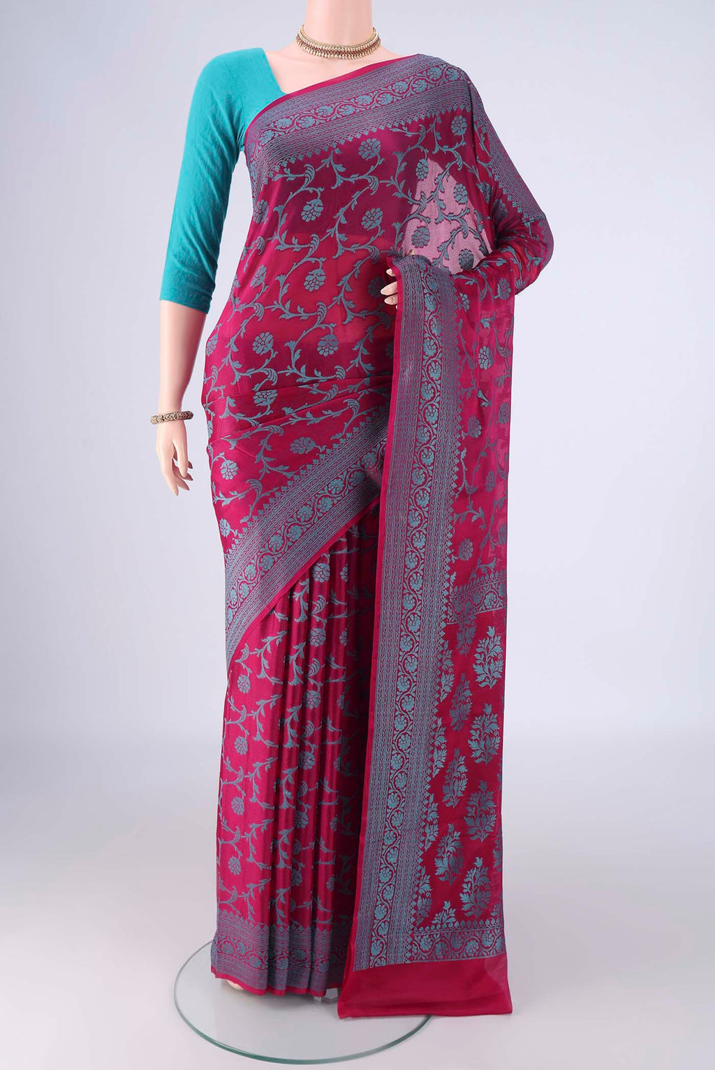 Magenta Blended Banarasi Georgette Saree with Thread Brocade on the body and Thread Border.  displayed on a mannequin