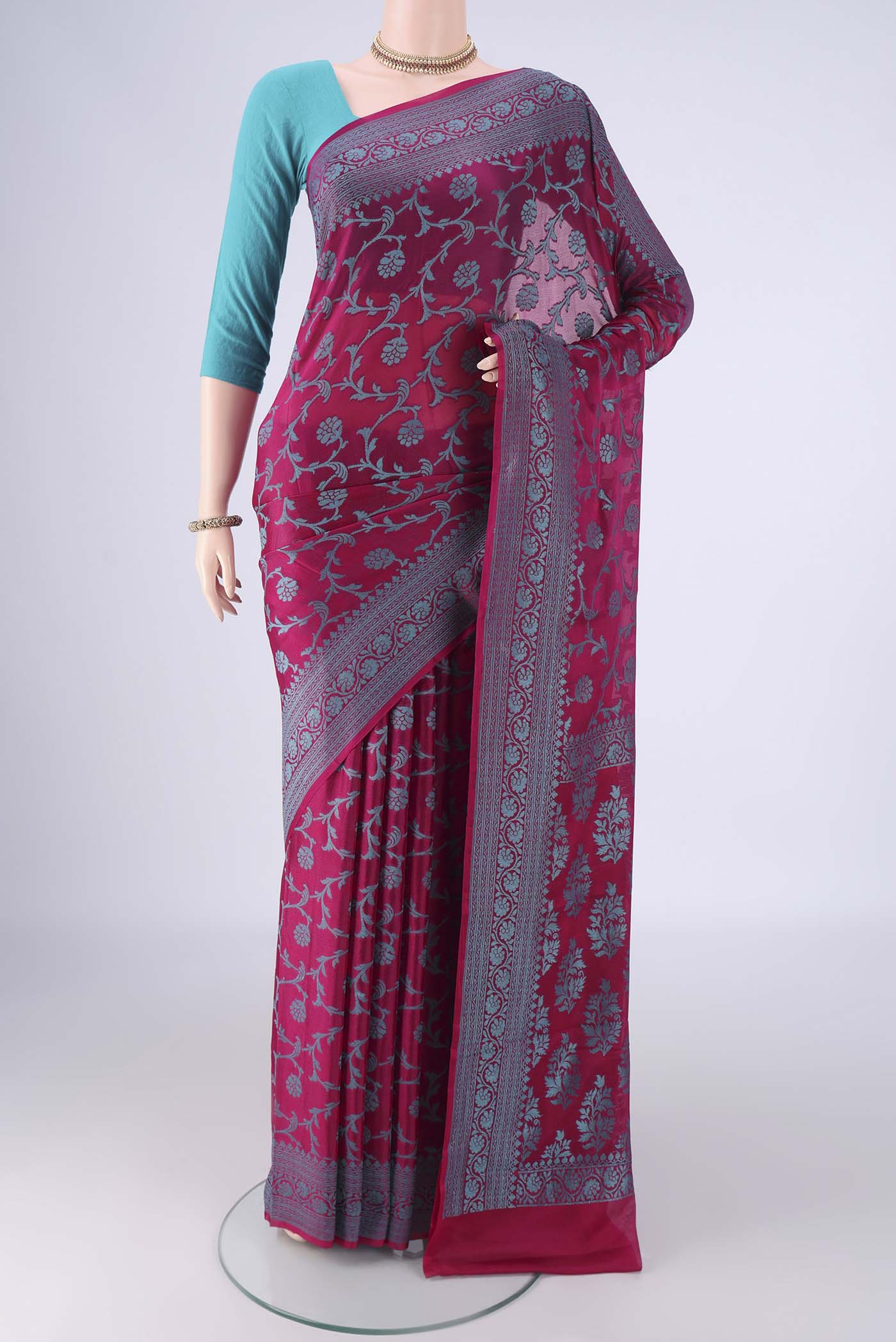 Magenta Blended Banarasi Georgette Saree with Thread Brocade on the body and Thread Border.  displayed on a mannequin