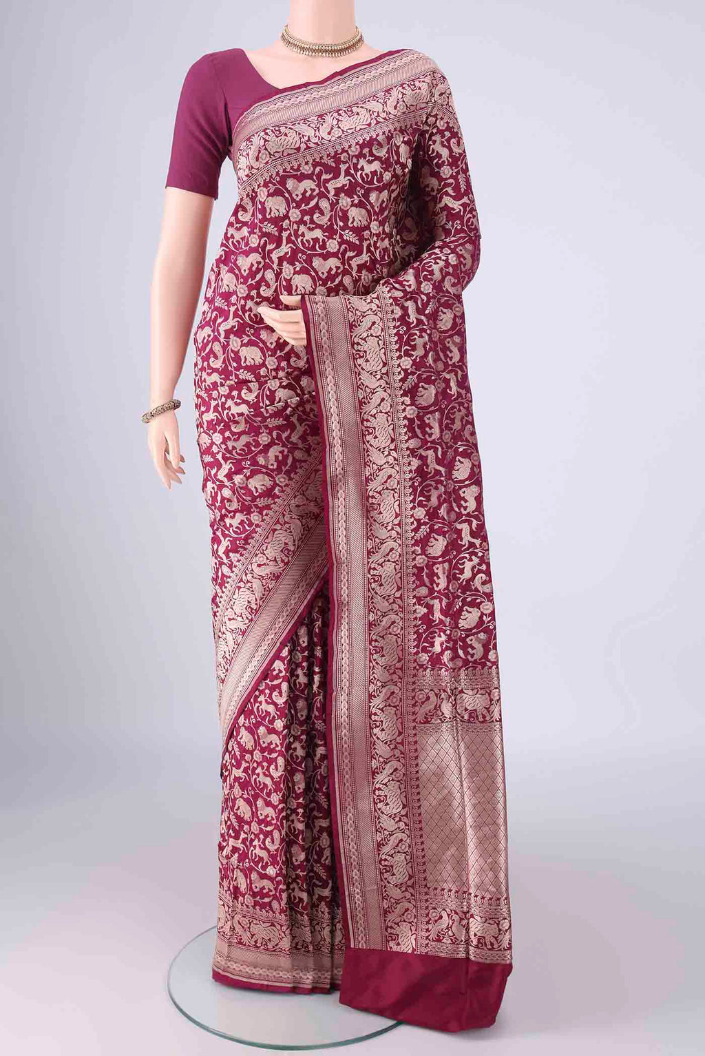Magenta Banarasi Silk Saree with Zari Brocade on the body and Zari Border.  displayed on a mannequin
