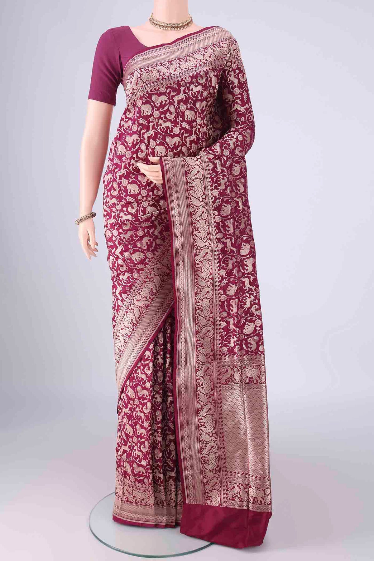 Magenta Banarasi Silk Saree with Zari Brocade on the body and Zari Border.  displayed on a mannequin
