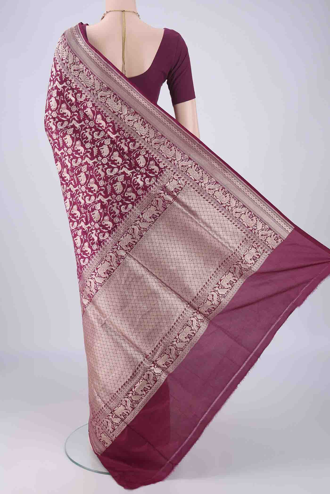 Flat view of Magenta Banarasi Silk Saree with Zari Brocade on the body and Zari Border. 