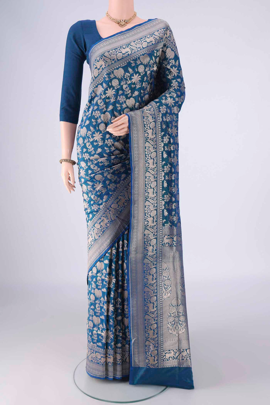 Peacock Blue Banarasi Silk Saree with Zari Brocade on the body and Zari Border.  displayed on a mannequin