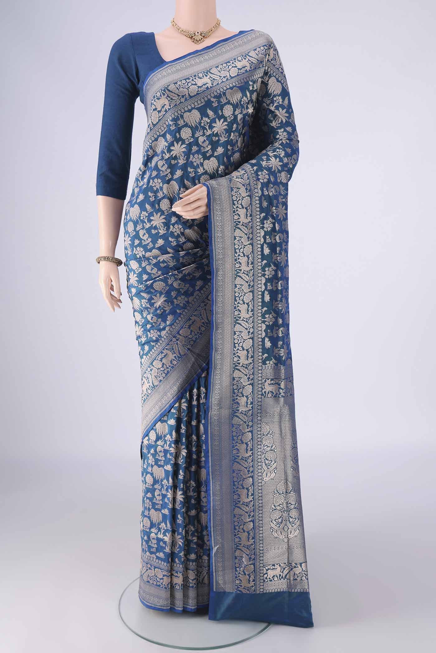 Peacock Blue Banarasi Silk Saree with Zari Brocade on the body and Zari Border.  displayed on a mannequin