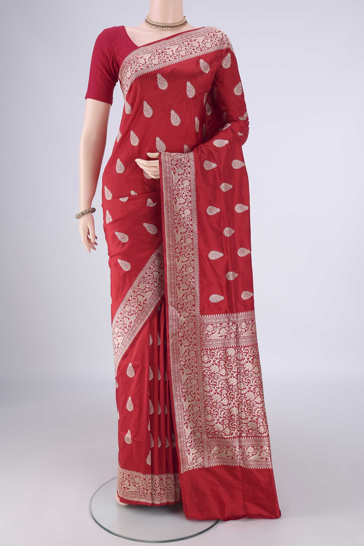 Red Banarasi Silk Saree with Zari Butta on the body and Zari Border.  displayed on a mannequin