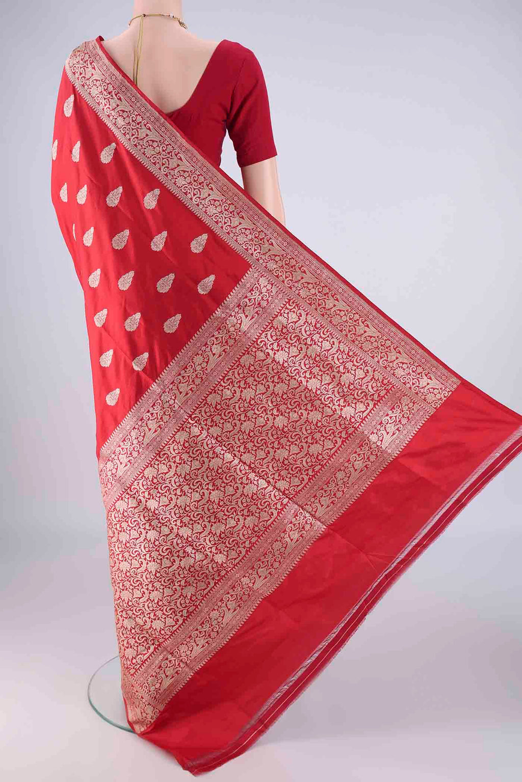 Flat view of Red Banarasi Silk Saree with Zari Butta on the body and Zari Border. 