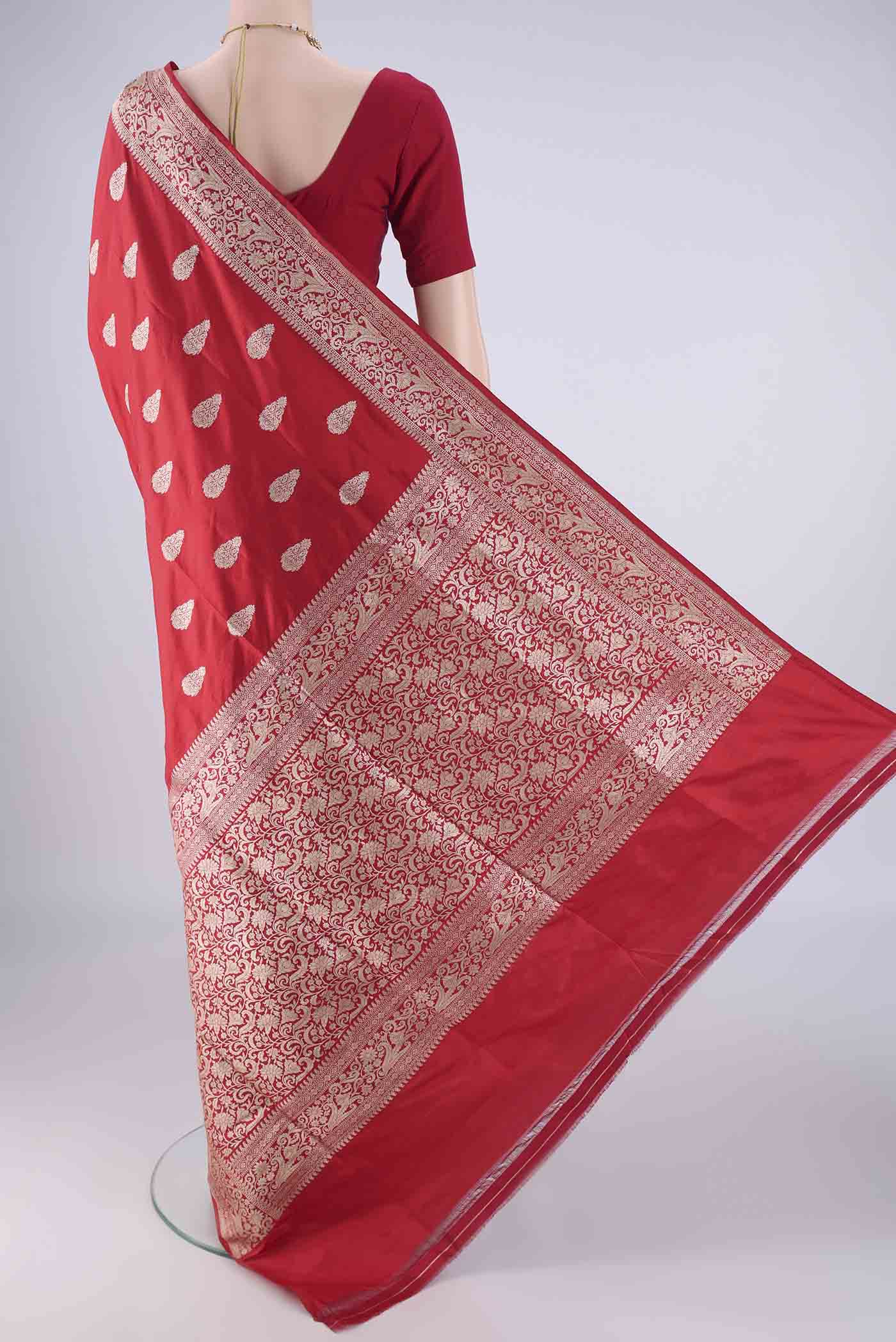 Flat view of Red Banarasi Silk Saree with Zari Butta on the body and Zari Border. 